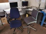 a desk with a chair and a computer on it