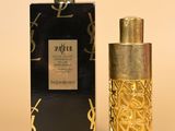 a close up of a bottle of perfume next to a box