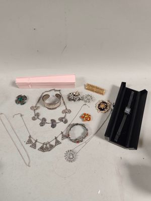 a lot of jewelry sitting on a white surface