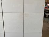 a white refrigerator in the middle of a room