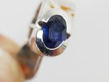 a close up of a ring with a blue stone in it