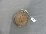 a small purse with a tag on it sitting on a table