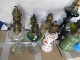 many different types of glass vases on a table