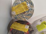two balls of yarn and a ball of yarn in a box