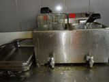 two deep fryers sitting on the counter in the kitchen