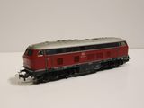 a red and black train on a white surface