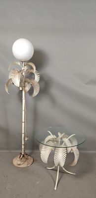 a glass table with a lamp and a palm tree on it