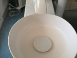 a white sink sitting on top of a white counter