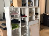 a room with a bunch of boxes on the shelves