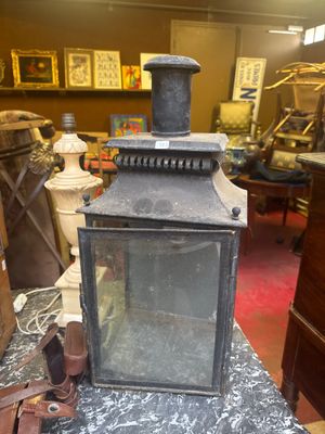 a small lantern sitting on top of a table in a room
