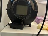 a clock that is sitting on a shelf in a room