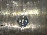a close up of a metal object with writing on it