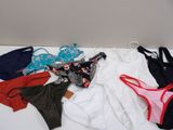 a lot of underwear that are laying out on the floor