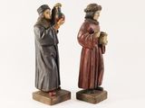 two figurines of a man and a woman standing next to each other