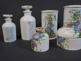 five vases with different designs on them sitting on a table