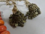 two necklaces that are on a table with a rope