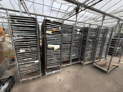 many trays of food inside of a large greenhouse
