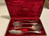 an antique silverware set in a red velvet case