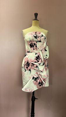 a dress on a mannequin stand with a pink and black floral print