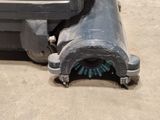 an old cannon sitting on the ground next to a trash can