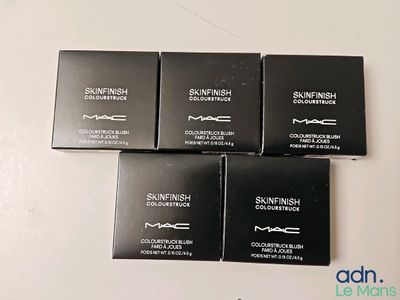 three mac cosmetics products sitting on top of a white table