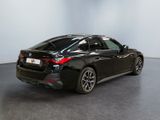 the rear end of a black bmw vehicle in a room
