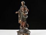 a bronze statue of a woman holding a child on a rock