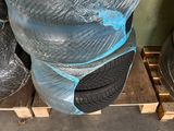 several pairs of shoes are wrapped in plastic on a pallet
