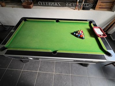 a pool table with a billiards rack and a ball on it