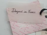 a pink tag with a picture of a woman on it