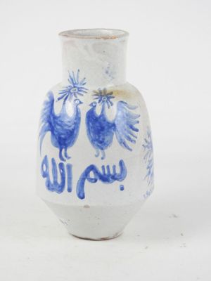 a blue and white vase with two birds on it