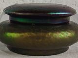 a green and purple vase sitting on a table