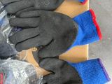 three pairs of gloves sitting on top of a box on top of a table