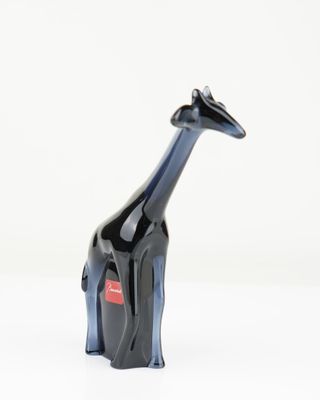 a black and blue giraffe figurine sitting on a white surface