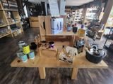 a wooden table with various items on it in a store