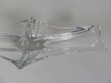 a clear glass object with a cross on it