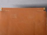 a close up of a brown leather case on a table