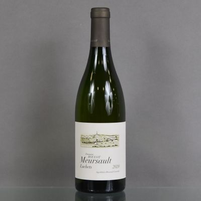 a bottle of wine sitting on a glass table