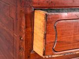 a wooden dresser with a drawer on top of it