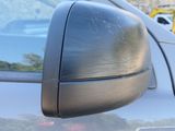 a close up of a car ' s side mirror with a sticker on it