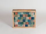 a small wooden box with a multicolored pattern on it