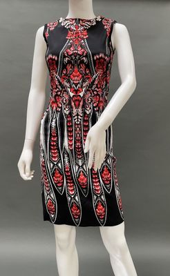 a mannequin wearing a black and red dress with red flowers on it