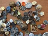 many different types of buttons on a wooden table