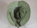 a green hat with a knot around the brim of it