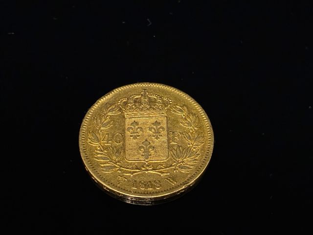 Une pièce de monnaie en or à valeur faciale de 40 francs Louis XV...