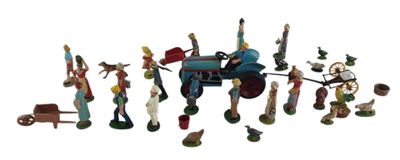de nombreuses figurines représentant des personnes rassemblées autour d'un tracteur miniature