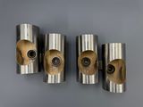 three silver metal wall sconces mounted on a gray wall