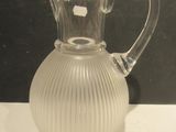 a clear glass pitcher sitting on a white table
