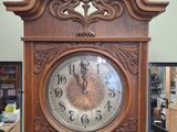 a wooden clock that is on display in a room