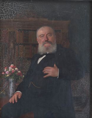 portrait of a man in a suit and tie sitting in a chair with a vase of flowers in front of him